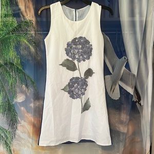 Cute, comfortable kids dress. Blue back with two flowers on the front.